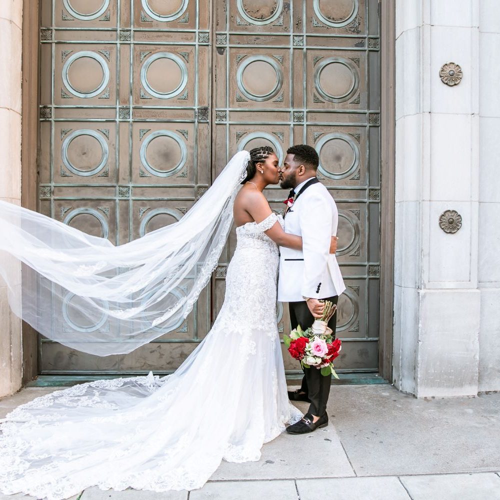 Newly married Memphis couple embracing one another in front of downtown Cadre for wedding planned by Simone Elise Events.